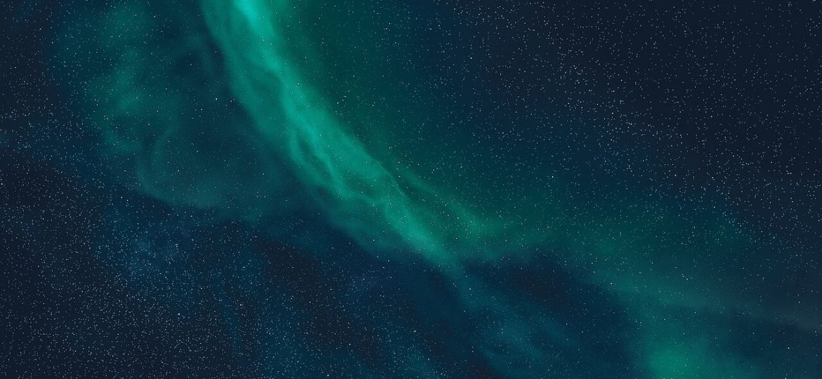 Green nebula over stars in the night sky