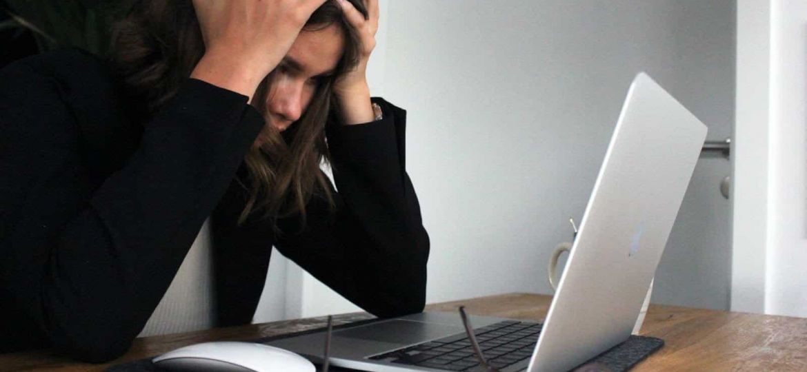 Woman frustrated working on her laptop